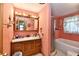 Charming bathroom featuring a vanity with Hollywood lights and a shower-tub combination at 1106 W 4Th St, Anderson, IN 46016