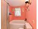 Bathroom featuring a soaking tub with shower and toilet at 1106 W 4Th St, Anderson, IN 46016