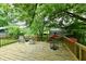 Spacious wooden deck perfect for relaxing and outdoor living, surrounded by lush greenery at 1106 W 4Th St, Anderson, IN 46016