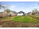 A spacious backyard with a wooden fence and green lawn on a clear day at 1216 N Ewing St, Indianapolis, IN 46201