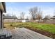 A spacious backyard with a wooden deck, wooden fence, small storage shed, and partially bare lawn at 1216 N Ewing St, Indianapolis, IN 46201