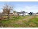 A spacious backyard with a wooden fence and a tree on a clear day at 1216 N Ewing St, Indianapolis, IN 46201