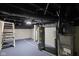 Basement with painted floors and walls, water heater, and stairs leading upwards at 1216 N Ewing St, Indianapolis, IN 46201