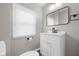 A modern bathroom with a new vanity, sink, and mirror, plus a window for natural light at 1216 N Ewing St, Indianapolis, IN 46201