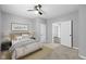 A cozy bedroom featuring neutral tones, carpet, and a ceiling fan for added comfort at 1216 N Ewing St, Indianapolis, IN 46201