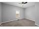 This bedroom features neutral paint, new carpet, a ceiling fan and natural light from the window at 1216 N Ewing St, Indianapolis, IN 46201