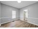Dining room with wood flooring, gray walls, white trim and natural light from the window at 1216 N Ewing St, Indianapolis, IN 46201