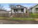 Charming home featuring a fenced yard, neutral paint and inviting curb appeal at 1216 N Ewing St, Indianapolis, IN 46201