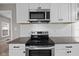 Stainless steel appliances, granite countertops, and white cabinets make for a modern kitchen at 1216 N Ewing St, Indianapolis, IN 46201
