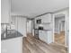 A modern kitchen featuring white cabinets, stainless steel appliances, and granite countertops at 1216 N Ewing St, Indianapolis, IN 46201