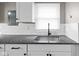 Granite countertops and white cabinetry are the highlights of this kitchen at 1216 N Ewing St, Indianapolis, IN 46201