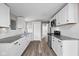 Modern kitchen with sleek countertops, stainless appliances, and white cabinetry and tile backsplash at 1216 N Ewing St, Indianapolis, IN 46201