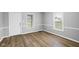 Living room featuring gray walls, white trim and beautiful hardwood flooring at 1216 N Ewing St, Indianapolis, IN 46201