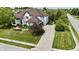 Elegant home featuring a pristine lawn, professional landscaping, and a spacious driveway at 14020 Brookstone Dr, Carmel, IN 46032
