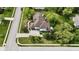 Beautiful aerial view of a home showcasing its expansive roof, landscaped yard, and long driveway at 14020 Brookstone Dr, Carmel, IN 46032