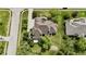 Stunning aerial shot of a house featuring a detailed roof, manicured lawn, and surrounding trees at 14020 Brookstone Dr, Carmel, IN 46032