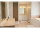 Bright bathroom with double vanities, a soaking tub, and a separate shower, offering a luxurious and relaxing experience at 14020 Brookstone Dr, Carmel, IN 46032