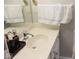 A bathroom vanity with a white countertop features a mirror and a chrome faucet at 14020 Brookstone Dr, Carmel, IN 46032
