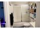 A clean bathroom features a shower with glass doors, a toilet, and built in storage shelves at 14020 Brookstone Dr, Carmel, IN 46032