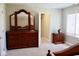 Bedroom featuring a dark wood dresser with mirror and a side table at 14020 Brookstone Dr, Carmel, IN 46032