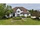 Beautiful white two-story home with a manicured lawn at 14020 Brookstone Dr, Carmel, IN 46032
