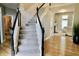 The home's foyer features a staircase with black and white banisters, and leads into a large living area at 14020 Brookstone Dr, Carmel, IN 46032