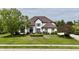 Charming two-story home with a lush green lawn, mature trees, and a welcoming front entrance at 14020 Brookstone Dr, Carmel, IN 46032