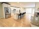 This spacious kitchen showcases stainless steel appliances, a kitchen island, white cabinets, and hardwood flooring at 14020 Brookstone Dr, Carmel, IN 46032