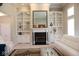 Bright living room features custom built-ins, a black fireplace, and comfortable seating at 14020 Brookstone Dr, Carmel, IN 46032