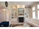 Bright living room featuring built-in shelving, a cozy fireplace, and comfortable seating, ideal for Gathering gatherings at 14020 Brookstone Dr, Carmel, IN 46032