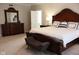 Spacious main bedroom featuring a stylish bed, dresser, and ample natural light, perfect for relaxation and comfort at 14020 Brookstone Dr, Carmel, IN 46032