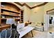 The office features custom-built shelves, a large window, a desk, and recliner chairs, creating a comfortable workspace at 14020 Brookstone Dr, Carmel, IN 46032