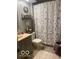 Cozy bathroom featuring decorative shower curtain, vanity and shelving at 1425 Winding Trail Cir, Greenwood, IN 46142