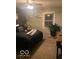 Well-lit bedroom with neutral paint, a queen bed, and a large potted plant at 1425 Winding Trail Cir, Greenwood, IN 46142