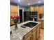 Updated kitchen with a center island, modern appliances, and beautiful granite countertops at 1425 Winding Trail Cir, Greenwood, IN 46142