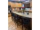 Kitchen with large island featuring barstool seating, wood cabinets, and stainless steel appliances at 1425 Winding Trail Cir, Greenwood, IN 46142