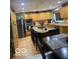 Open kitchen area with a large island, barstool seating, stainless steel appliances, and hardwood floors at 1425 Winding Trail Cir, Greenwood, IN 46142