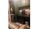 A practical laundry space featuring stacked washer and dryer and black countertops at 1425 Winding Trail Cir, Greenwood, IN 46142