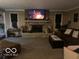 Relaxing living room featuring a cozy stone fireplace and comfortable furnishings at 1425 Winding Trail Cir, Greenwood, IN 46142