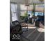 Bright sunroom featuring wicker furniture, lush plants, and a view of the inviting outdoor pool at 1425 Winding Trail Cir, Greenwood, IN 46142