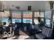 Relaxing sunroom with comfortable wicker seating, many plants, and a view of the backyard swimming pool at 1425 Winding Trail Cir, Greenwood, IN 46142