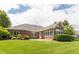 Expansive backyard featuring lush green grass and a brick exterior of the home at 1589 Belleflower Ct, Avon, IN 46123