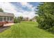Expansive backyard featuring lush lawn, mature trees, and view of neighboring homes in the community at 1589 Belleflower Ct, Avon, IN 46123