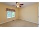 This inviting bedroom includes a ceiling fan, large window, and carpet flooring for a cozy, warm space at 1589 Belleflower Ct, Avon, IN 46123