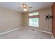 A carpeted bedroom, complete with ceiling fan and natural light, offers comfortable living and style at 1589 Belleflower Ct, Avon, IN 46123