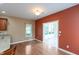 Open dining area with hardwood floors, view of a sunroom, and access to the kitchen at 1589 Belleflower Ct, Avon, IN 46123