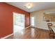 Open dining area with hardwood floors, view of a sunroom, and access to backyard at 1589 Belleflower Ct, Avon, IN 46123