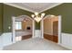 Elegant dining room featuring a chandelier, decorative columns, and view into the living room at 1589 Belleflower Ct, Avon, IN 46123