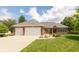 Charming brick home with a manicured lawn, three car garage, and stone landscaping at 1589 Belleflower Ct, Avon, IN 46123