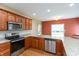 Modern kitchen with stainless steel appliances, granite countertops, and wooden cabinetry at 1589 Belleflower Ct, Avon, IN 46123